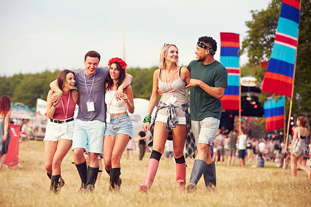 istock Friends walking through a music festival site 482464196