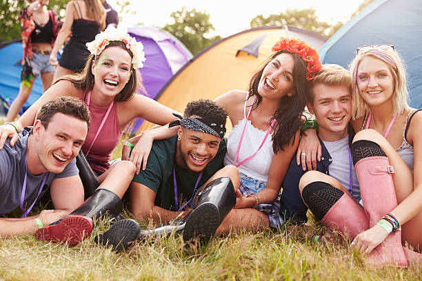 Friends having fun on the campsite at a music festival Friends having fun on the campsite at a music festival music festival camping summer vacations stock pictures, royalty-free photos & images