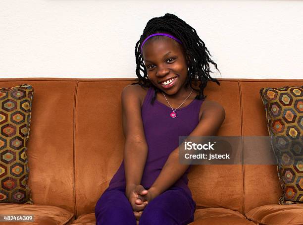 African American Teenager Sitting On Couch Stock Photo - Download Image Now - Adolescence, African Ethnicity, African-American Ethnicity