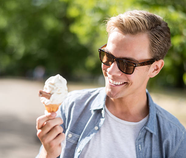 Man eating an ice cream at the park