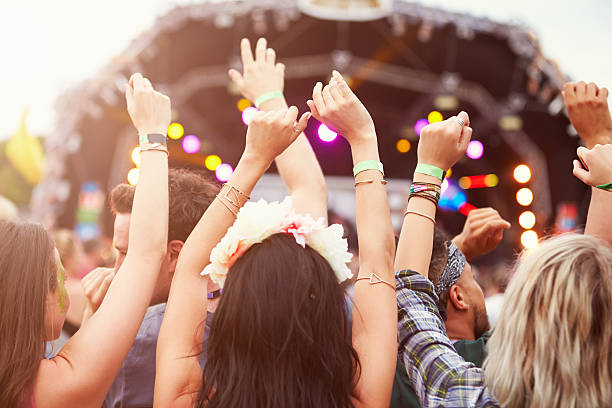 Audience with hands in the air at a music festival Audience with hands in the air at a music festival music festival stock pictures, royalty-free photos & images