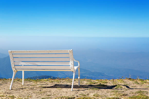 istock White bench on the hill with the sky. 482465705