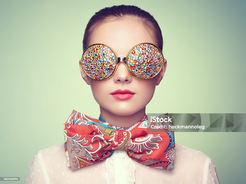 Portrait of beautiful young woman with colored glasses Portrait of beautiful young woman with colored glasses. Beauty fashion. Perfect make-up. Colorful decoration. Jewelry Costume Jewelry Stock Photo