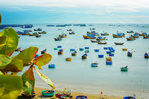 Vietnamese boats at sea in the distance, fishermen harbour
