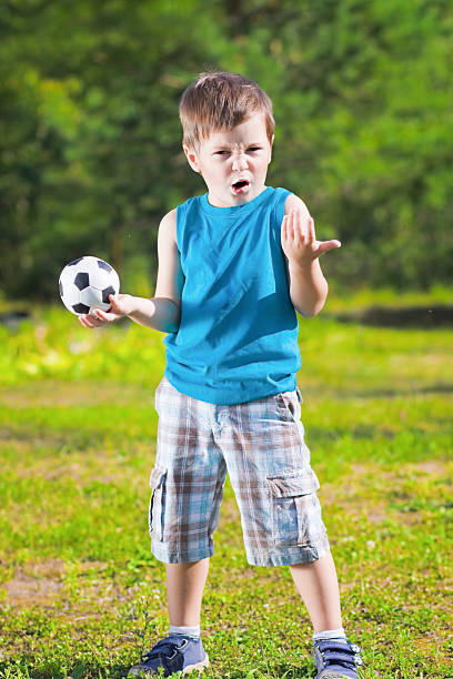 istock cute boy with football ball 482470425