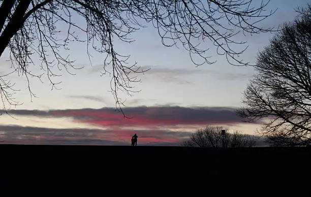 A beautiful scene of onlookers enjoying the beautiful sunset.