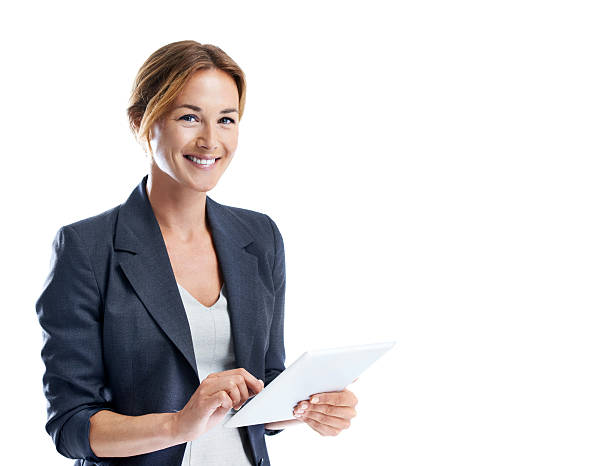 I can do all my business on the go now! Cropped shot of a smiling businesswoman using a digital tablet while isolated on white woman waist up stock pictures, royalty-free photos & images