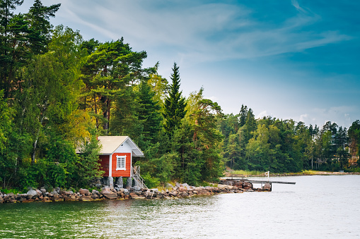 Red Finnish Wooden Sauna Log Cabin On Island In Summer