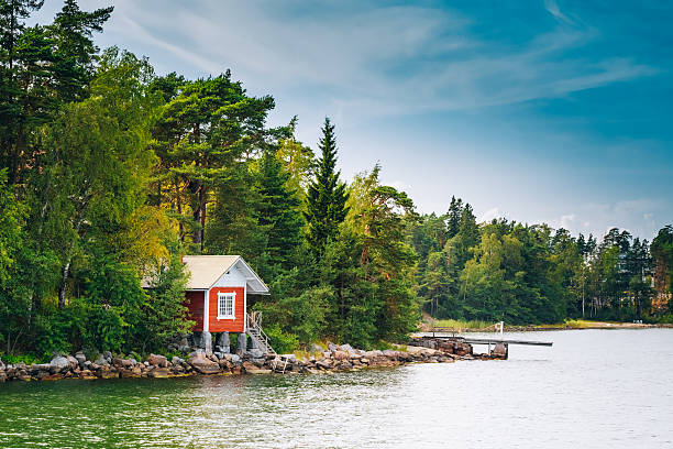 Red Finnish Wooden Bath Sauna Log Cabin In Summer Red Finnish Wooden Sauna Log Cabin On Island In Summer northern europe stock pictures, royalty-free photos & images