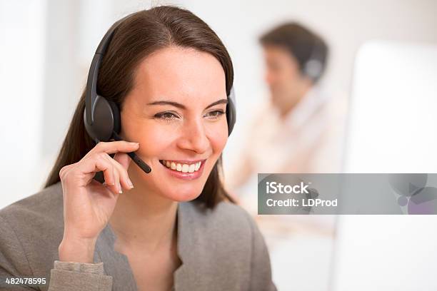 Helpline Operator With Computer In Office Headset Stock Photo - Download Image Now - Adult, Assistant, Beautiful People