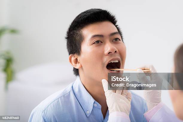 Throat Examination Stock Photo - Download Image Now - Tongue Depressor, 2015, Adult