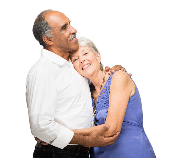 istock Happy mature couple holding each other on white background 482483549