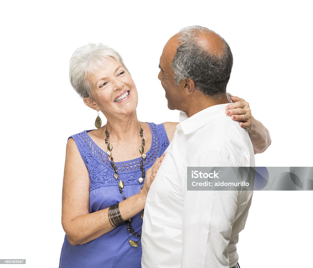 Mature romantic couple in love A mature romantic couple in love smiling at each other. Isolated on a white background. 60-69 Years Stock Photo