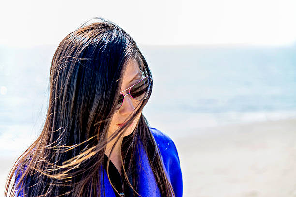 istock Young asian woman on beach 482485132
