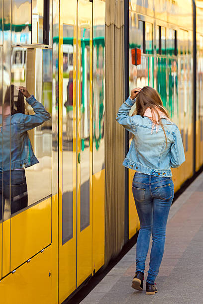 istock young woman in the tram stop 482489673