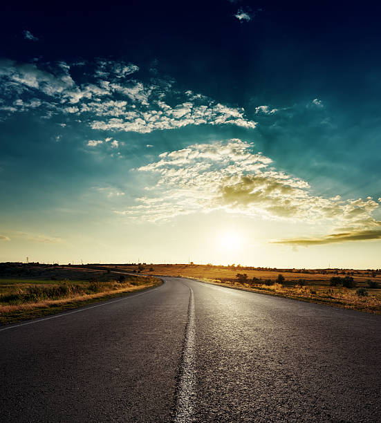 istock sunset over asphalt road with white line 482490558
