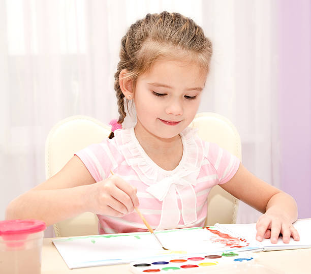 istock Cute smiling little girl drawing with paint 482490726