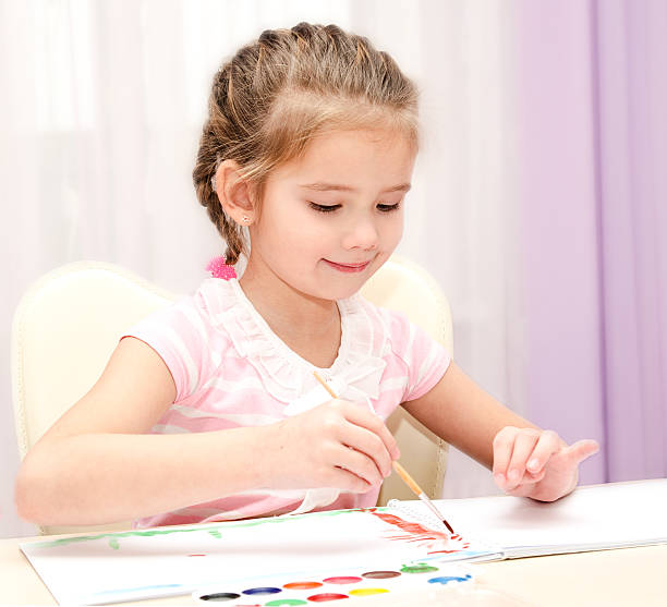 istock Cute smiling little girl drawing with paint 482490730