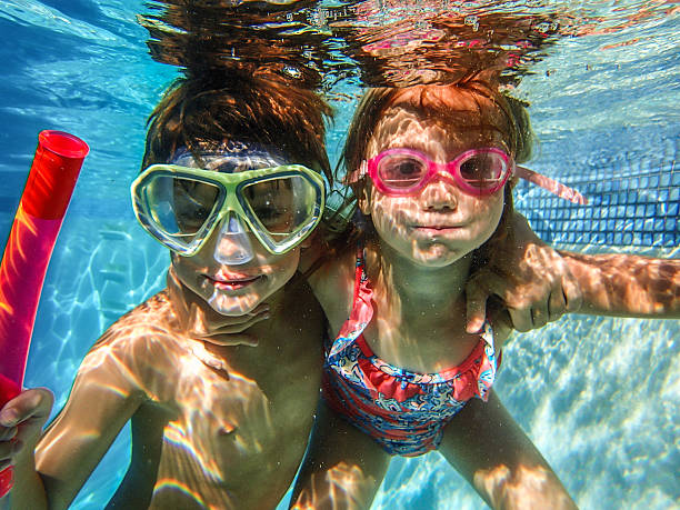 istock Two 2 happy kids in swimming pool underwater 482493125