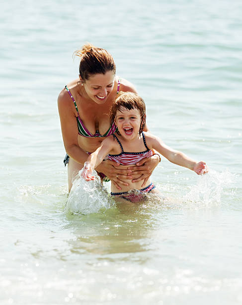 istock mother with child in sea 482493405