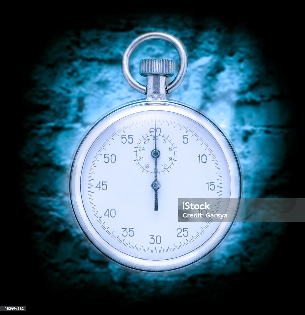 Stopwatch on wall background Stopwatch on cracked wall background in blue toning 2015 Stock Photo