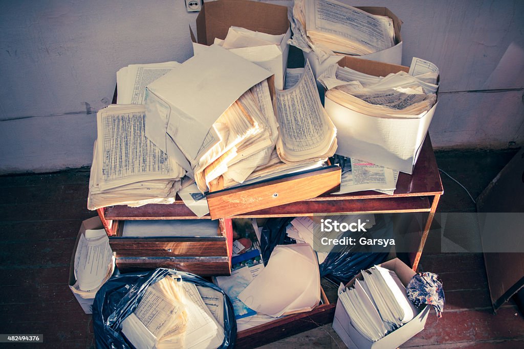 Messy workplace Messy workplace with table and stack of paper 2015 Stock Photo