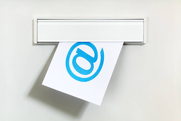 E-mail through letterbox E-mail symbol on letter being delivered through a letterbox concept for internet communication, social media and contact us junk mail photos stock pictures, royalty-free photos & images