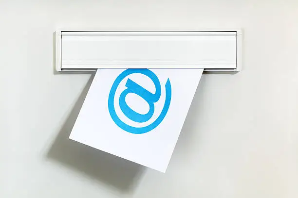 E-mail symbol on letter being delivered through a letterbox concept for internet communication, social media and contact us