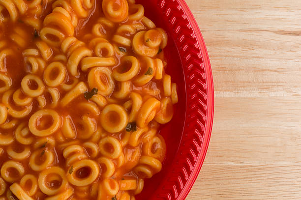 istock Round spaghetti in a tomato sauce on red plate 482496180