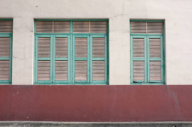 istock Vintage green window on aged wall 482499650