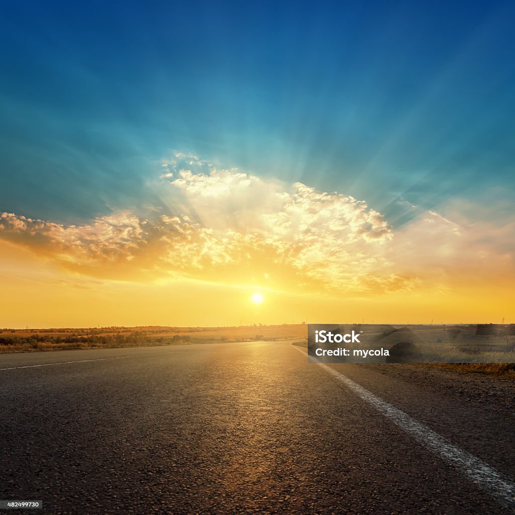 asphalt road and sunset in clouds Road Stock Photo