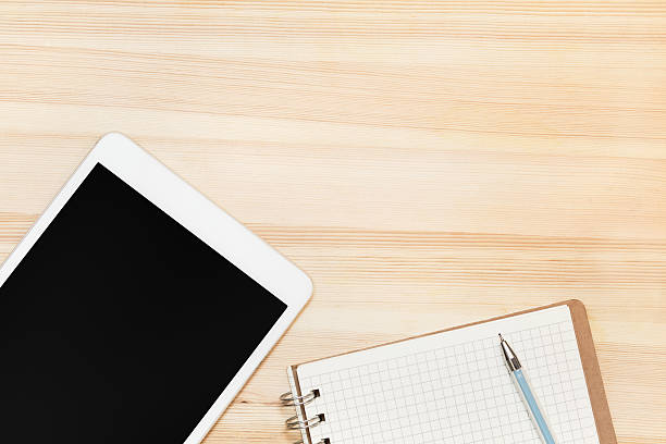 istock digital tablet and paper on wooden table 482500402
