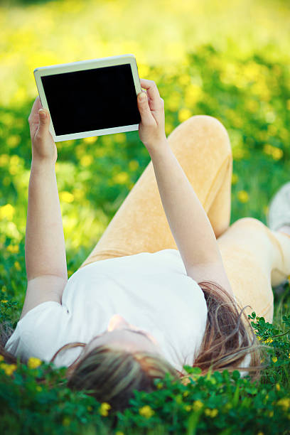 istock Beautiful woman using digital tablet in park 482503651