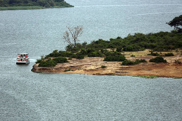 Katunguru, Uganda - December 29, 2013: Tour boats allow visitors an unprecedented experience seeing the wildlife up close from the water, as they gather along the Kazinga Channel.