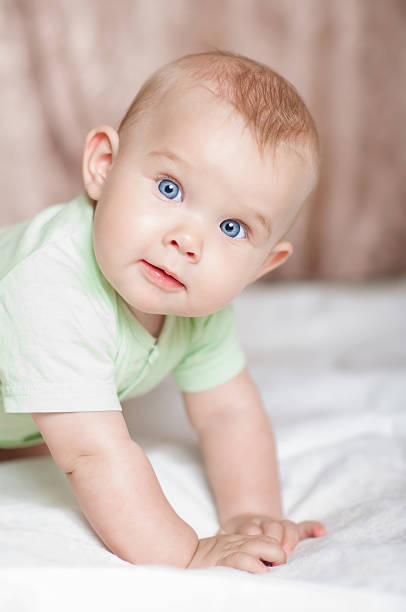 istock Sweet baby on the bed smiling 482507175