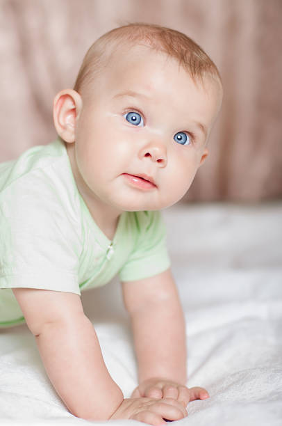 istock Sweet baby on the bed smiling 482508601