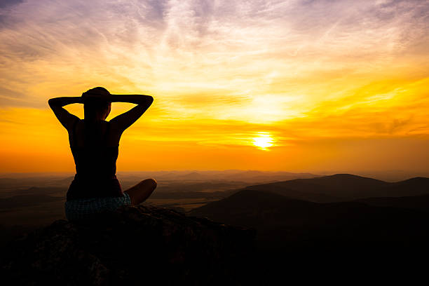 istock single adult woman silhouette on rock 482508794