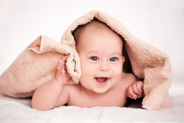 istock baby girl is hiding under the white blanket 482508847
