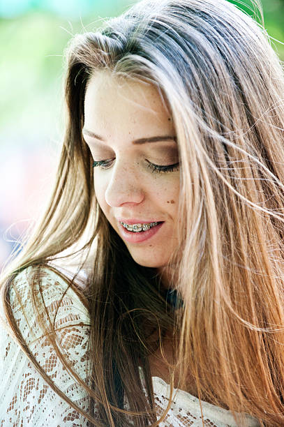 istock Beautiful young girl with brackets on teeth 482511055