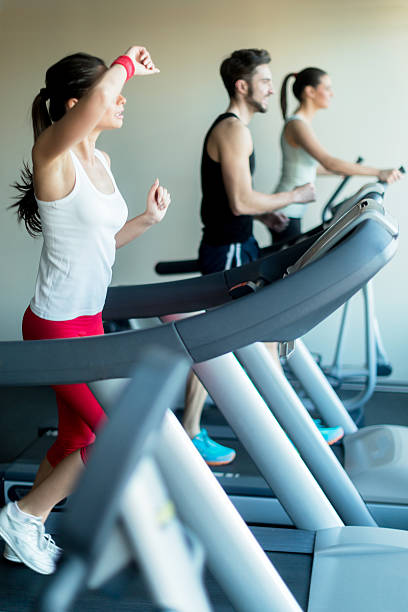 istock Young and beautiful  lady running on a treadmill and sweating 482511106