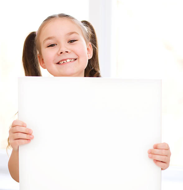 istock Cute girl is holding blank banner 482511275