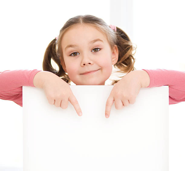istock Cute girl is holding blank banner 482511379