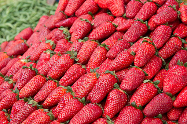 Strawberries Stacked in Market stock photo