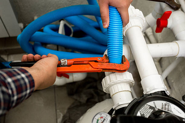 istock plumber connecting two pipes with red pliers 482515410