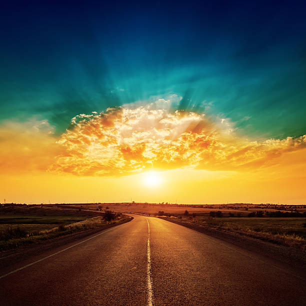 istock orange sunset and asphalt road to horizon 482516966