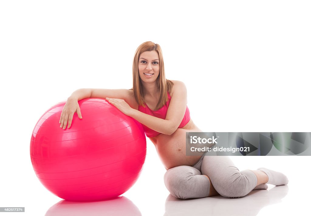 Pregnant woman relaxing after exercise with ball Pregnant woman relaxing after exercise with ball isolated 2015 Stock Photo