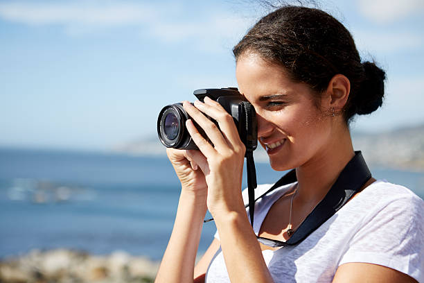 istock woman taking pics of the ocean 482519604
