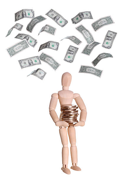istock wooden doll with coins and dollars 482519675
