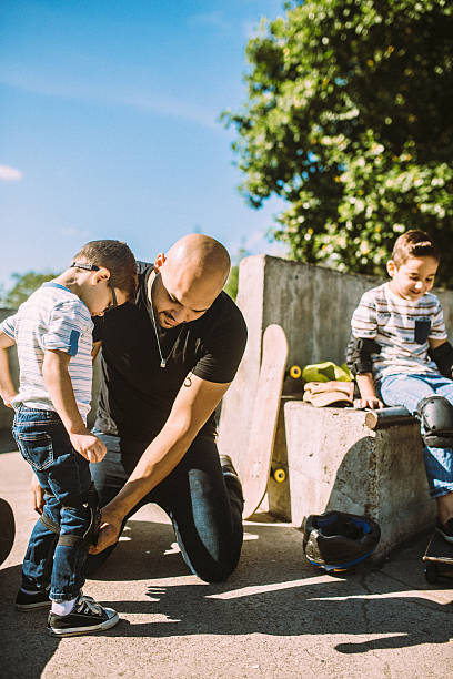 istock Father and Sons at Skate Park 482519736