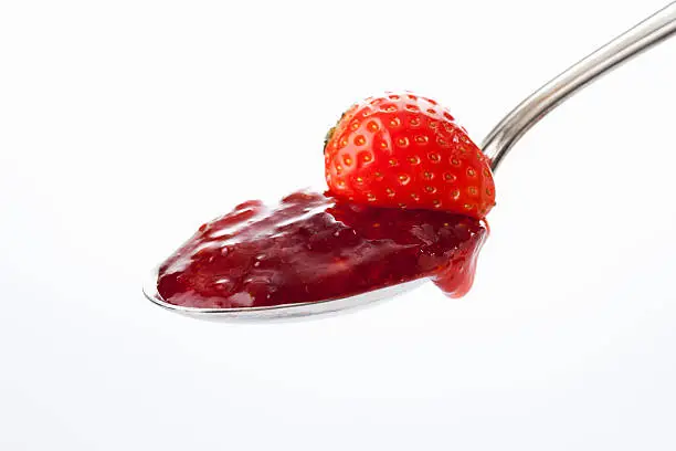 Spoon with strawberry jam and strawberry